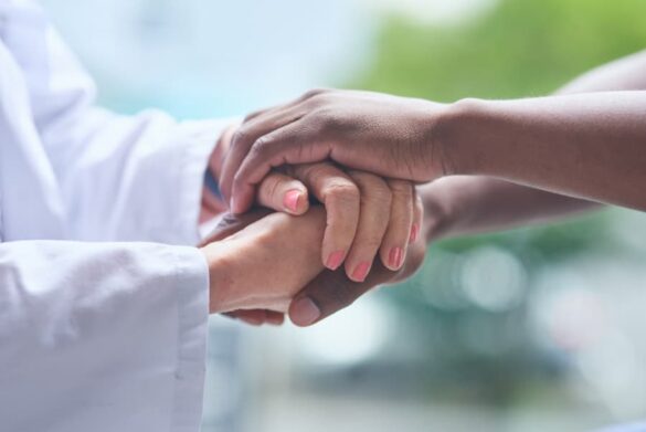 Caregiver holding hands with client