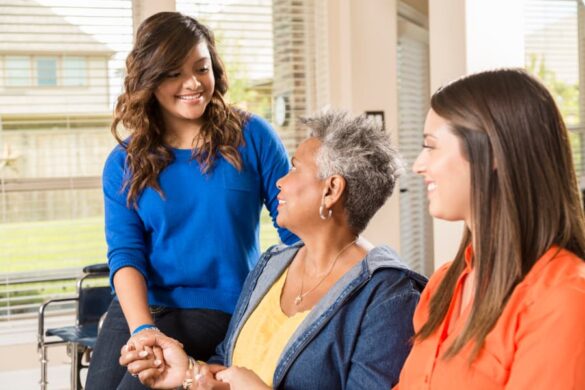 Caregivers visit with a woman 