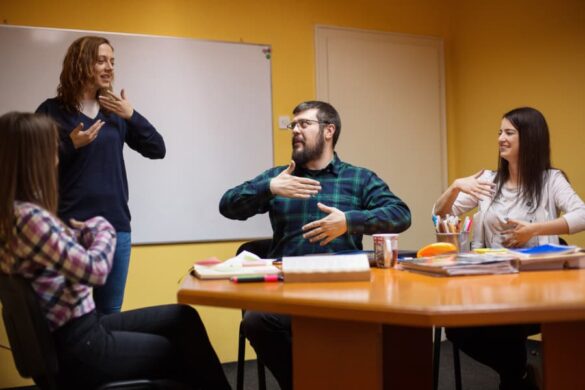 Group of people learning sign language 