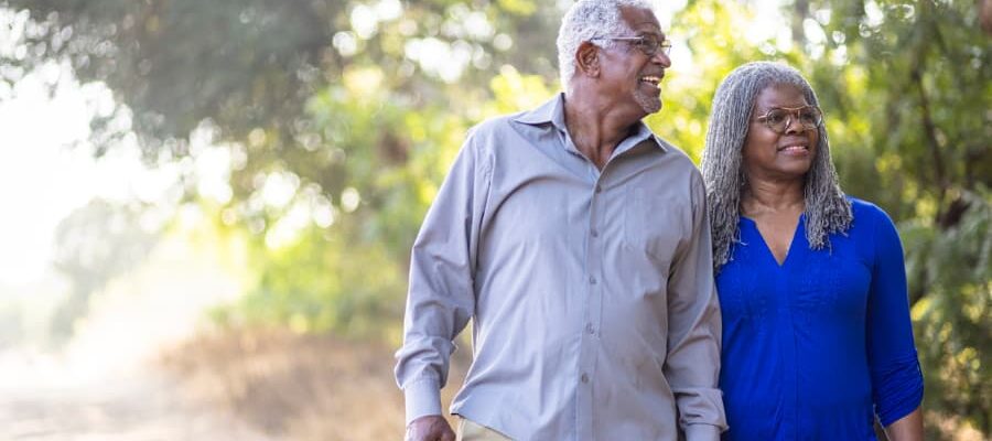 Senior couple enjoying a nice walk on a trail