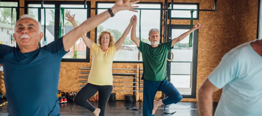 Seniors balancing during yoga class