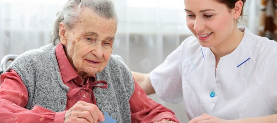 Caregiver helping senior complete a puzzle