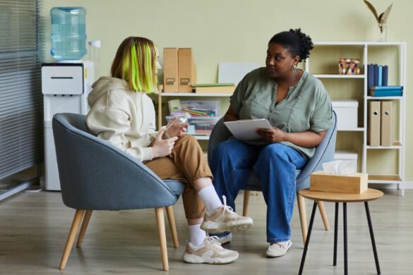 Social worker talking with client in office