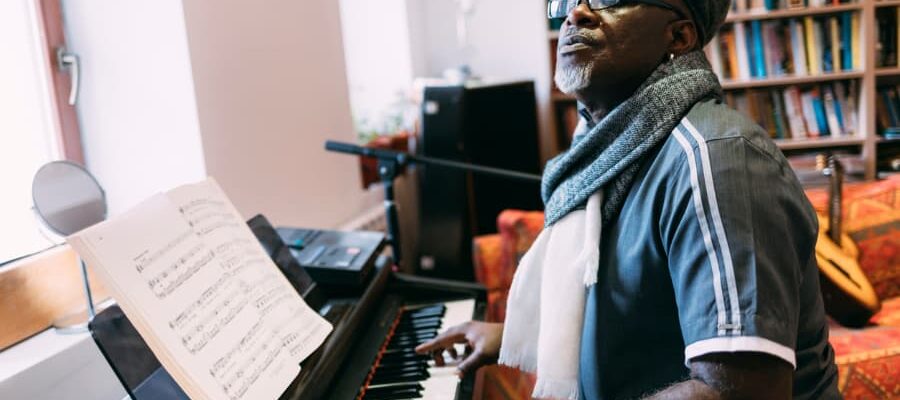 A man plays piano and sings