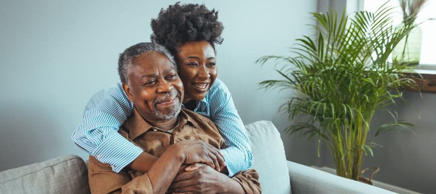 Family caregiver hugging their elderly relative