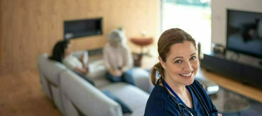 Portrait of nurse with stethoscope at patient’s home