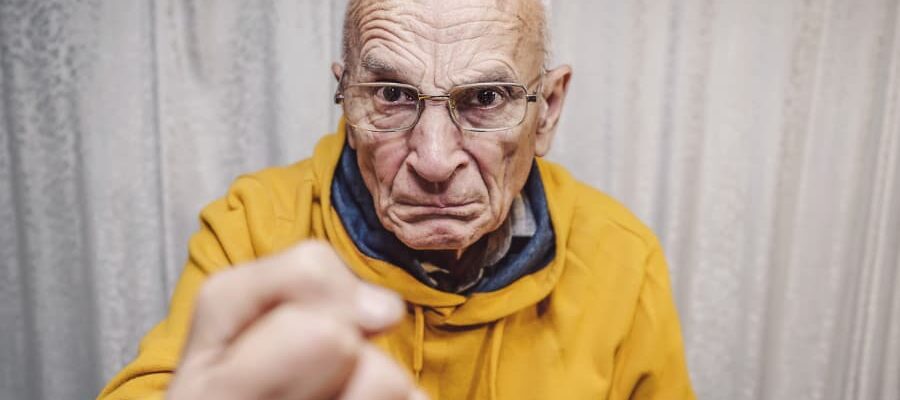 Aggressive patient shakes fist at unseen caregiver