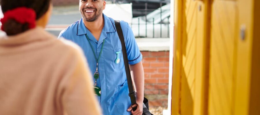 Resident greets smiling in-home caregiver at door